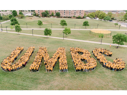 students in yellows spelling out UMBC