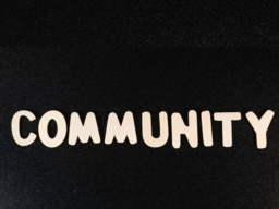 A black background with the word community in white letters on top.
