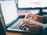 A picture showing someone typing on a computer.