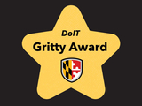 A gold star with the UMBC shield and text "DoIT Gritty Award"